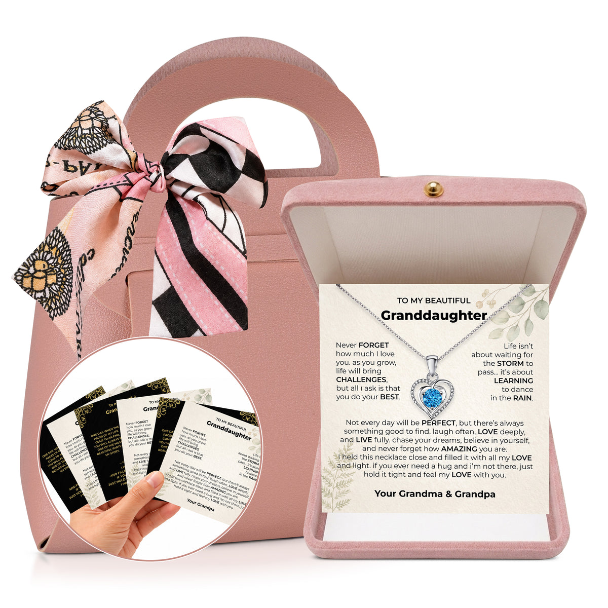 Open pink velvet gift box with a heart pendant necklace on a black and gold granddaughter message card