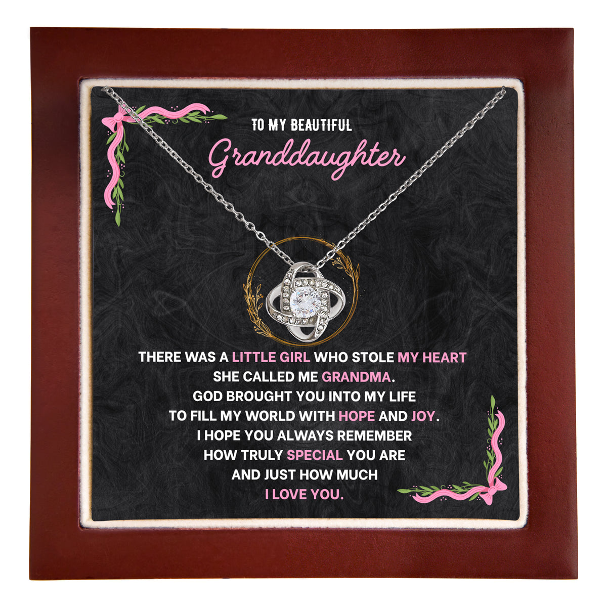 Hand holding an open wooden gift box with a granddaughter necklace resting on its message card