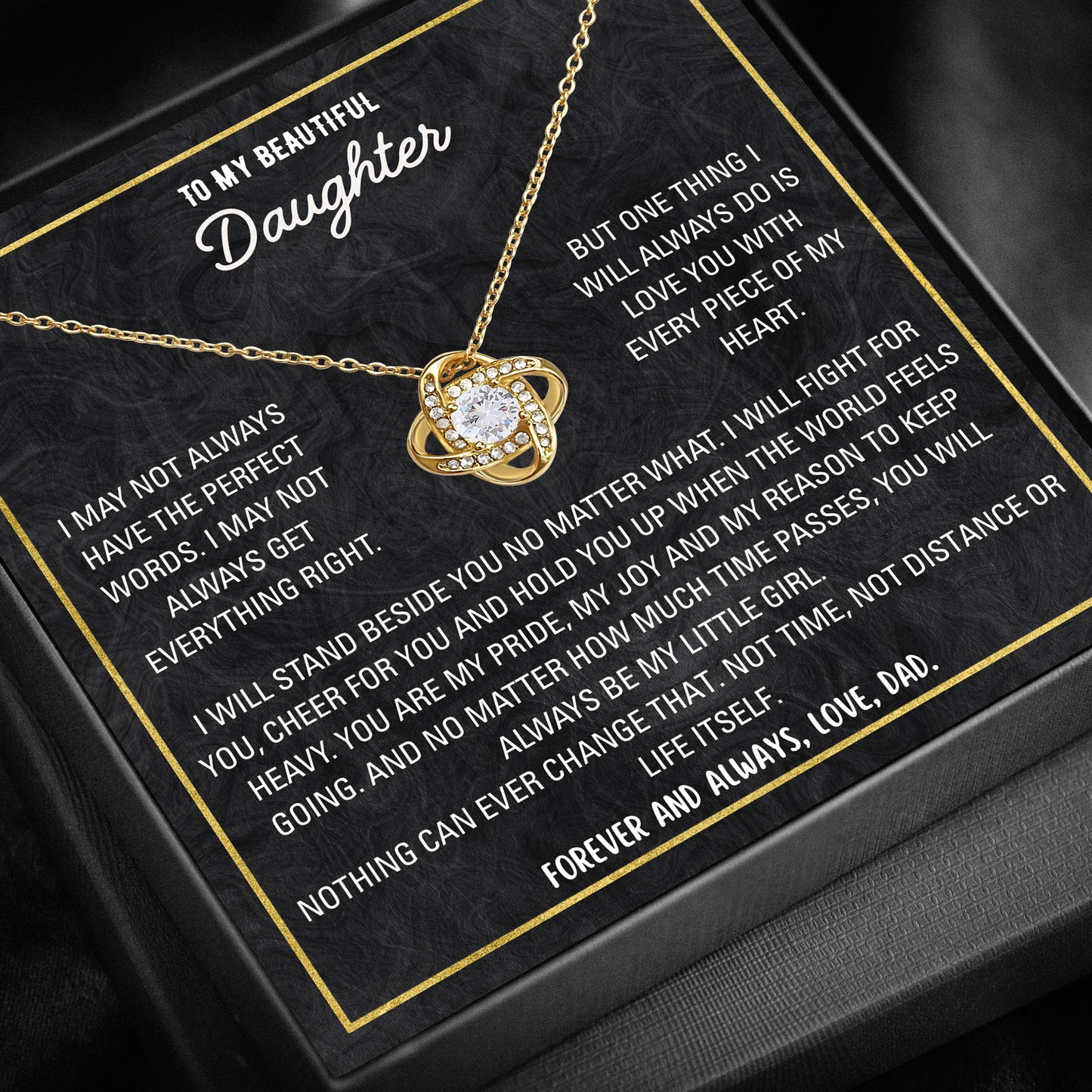 Close-up of love knot pendant necklace with cubic zirconia stone.