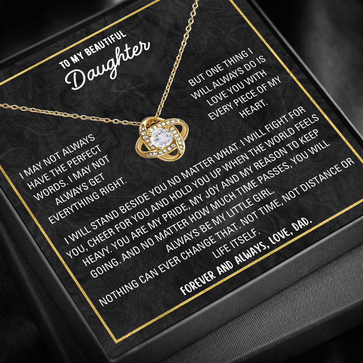 Close-up of love knot pendant necklace with cubic zirconia stone.