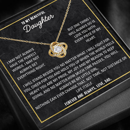 Close-up of love knot pendant necklace with cubic zirconia stone.