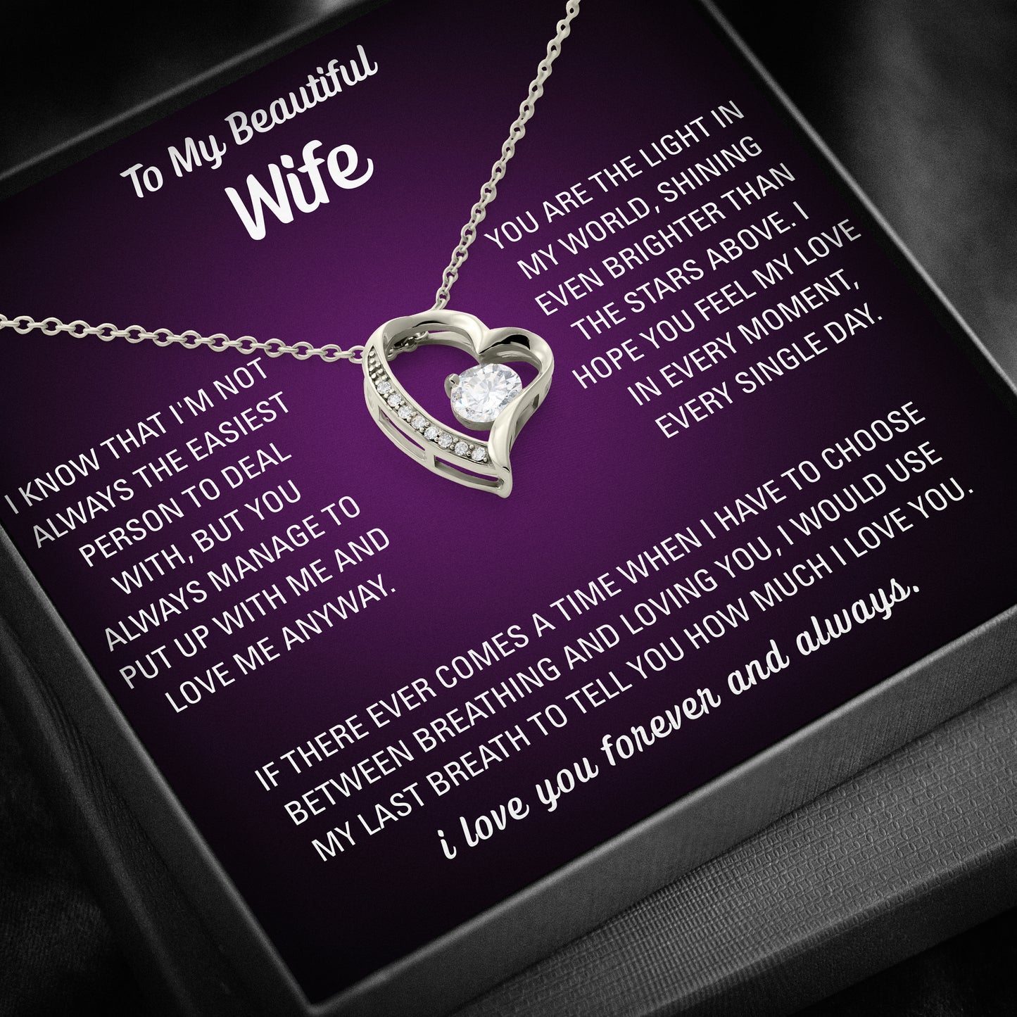 Silver heart necklace displayed on a purple To My Beautiful Wife message card inside a black gift box.