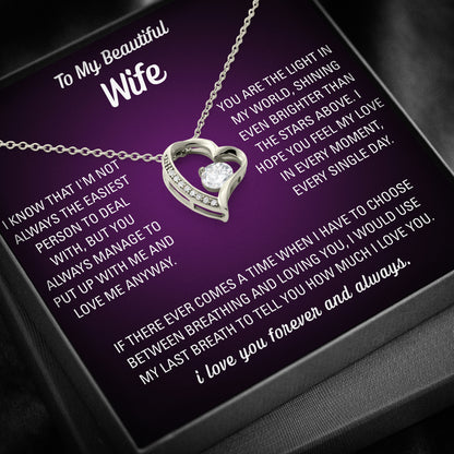 Silver heart necklace displayed on a purple To My Beautiful Wife message card inside a black gift box.