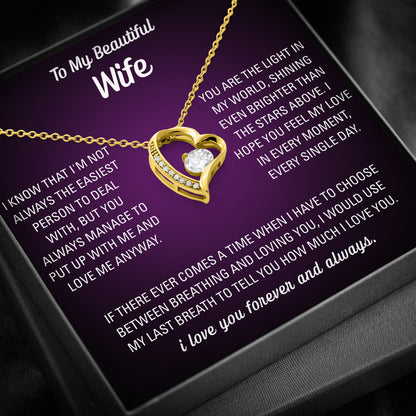 Silver heart necklace displayed on a purple To My Beautiful Wife message card inside a black gift box.