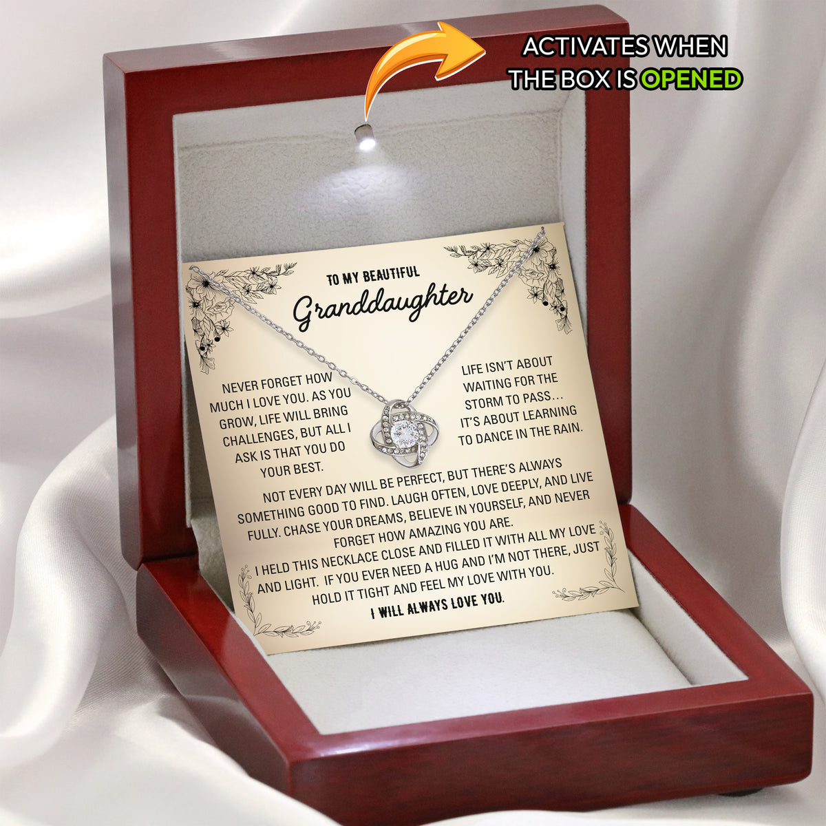 Hand holding the open wooden gift box with the granddaughter necklace and heartfelt message card inside

