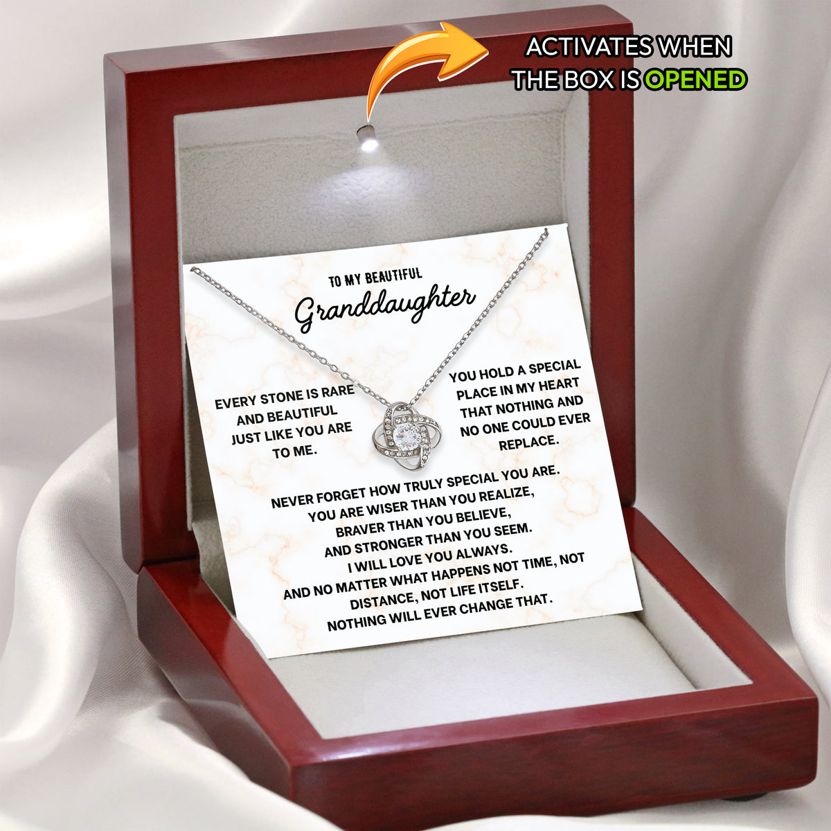 Open wooden gift box with LED light on, showing a love knot necklace on a granddaughter message card
