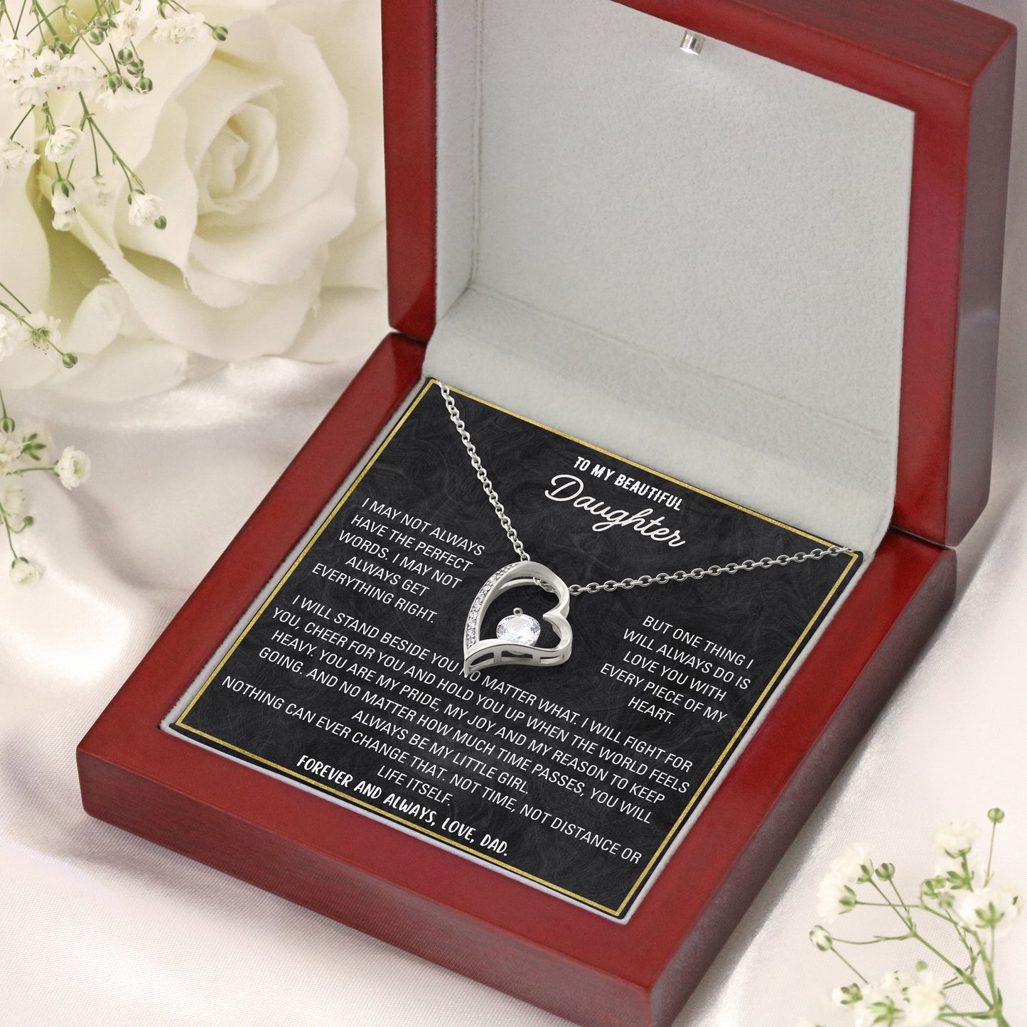 Close-up of stainless steel lobster clasp and cubic zirconia stone on a daughter necklace