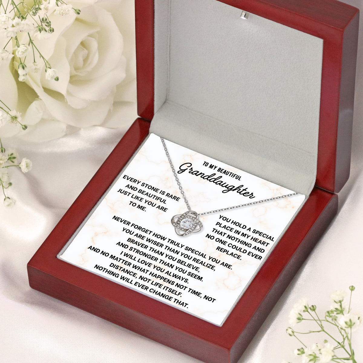 Open wooden gift box with LED light on, showing a love knot necklace on a granddaughter message card
