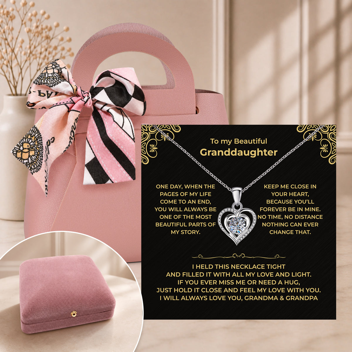 Pink gift bag with a scarf bow beside an open velvet box holding a granddaughter heart necklace and black card