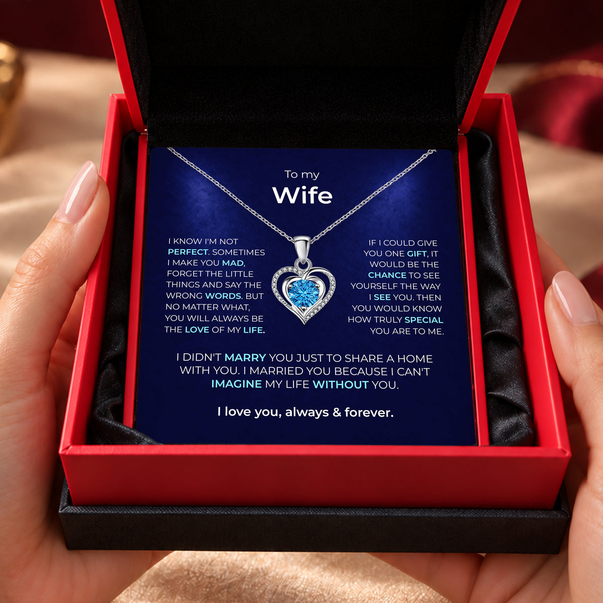 Double-heart pendant with a cubic zirconia centre stone, shown with pendant size and chain details