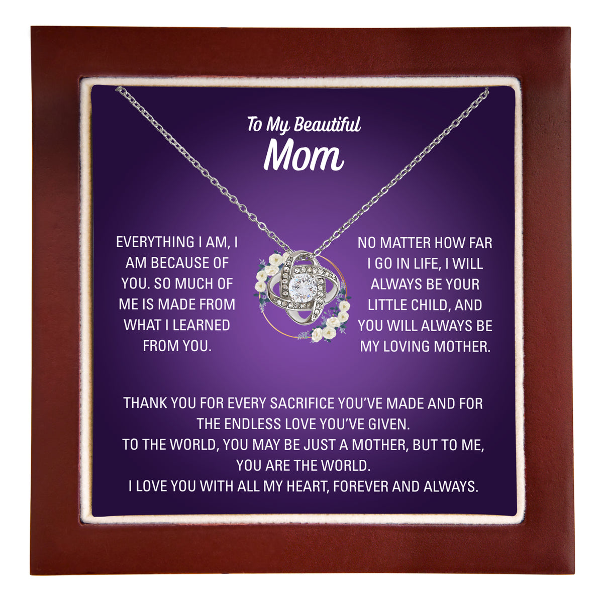 Silver heart necklace and To My Beautiful Mom message card against wooden jewellery box